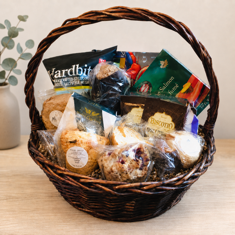Corporate sympathy gift basket with smoked salmon, gourmet snacks and freshly baked treats in a willow basket
