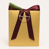 Beers of the World gift basket presented in a gold gift box with a burgundy satin bow for courier delivery