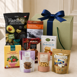 A curated gift box featuring Hardbite chips, Smoked salmon, Walkers cookies, Partners sea salt crackers, nougat, cashews, and herbal tea.