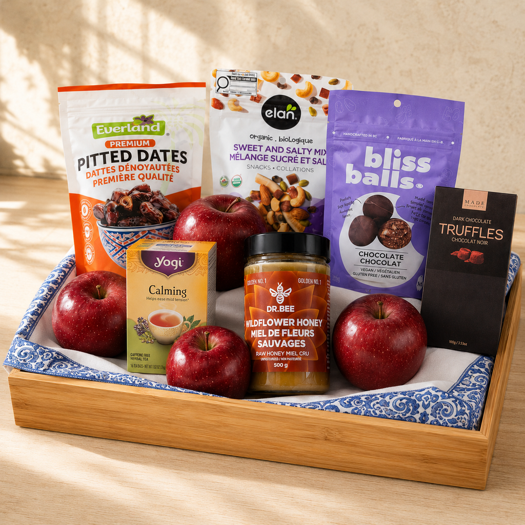 Sweet New Year Rosh Hashanah gift basket with red apples, Canadian honey, dates, tea and chocolate on a bamboo tray