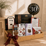 Milestone birthday gift basket with gourmet chocolates and a 30th birthday balloon