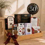 Milestone birthday gift basket with gourmet chocolates and a 50th birthday balloon